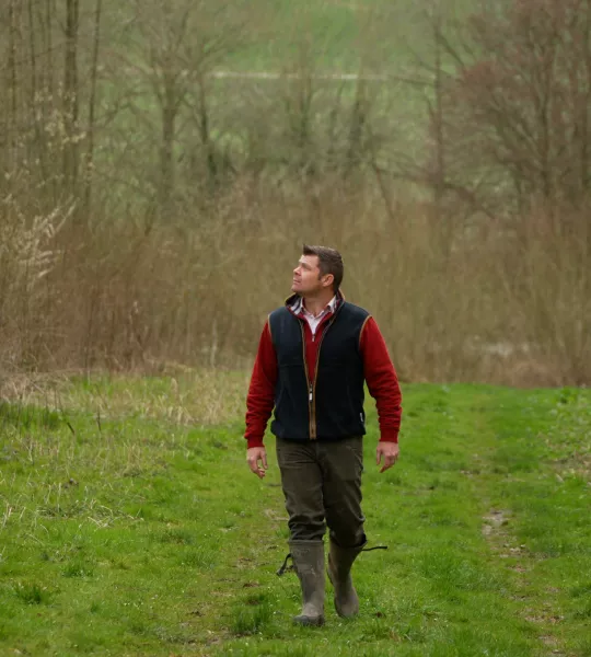 Peter walking through a woodland path